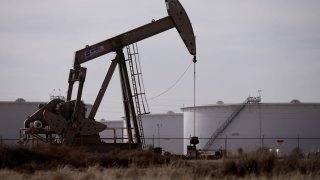 A pump jack operates near a gas turbine power plant in the Permian Basin oil field outside of Odessa, Texas, U.S. February 18, 2025.