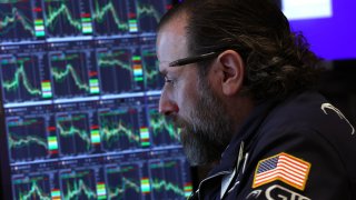 A trader works on the floor of the New York Stock Exchange (NYSE) at the opening bell on April 9, 2025, in New York City. 