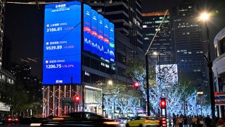 A screen showing the Shanghai composite index (top), Shenzhen component index (C) and Beijing stock exchange 50 index (bottom) in Jing’an district in Shanghai on April 9, 2025.
