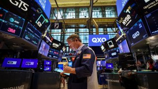 Traders work on the floor at the New York Stock Exchange in New York City, U.S., April 30, 2025.