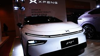 People visit XPENG booth at 2025 Spring International Auto Show in Qingdao, Shandong province, China, on March 7, 2025.