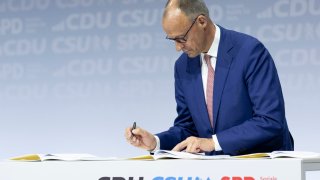 Friedrich Merz, leader of the Christian Democratic Union (CDU), signs the coalition contract between the CDU, the CDU’S Bavarian sister party, the Christian Social Union (CSU), and the German Social Democrats (SPD) on May 05, 2025 in Berlin, Germany.