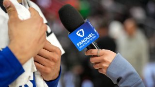 A detailed view of a hand holding a Fanduel Sports Network branded microphone during an interview after the Detroit Pistons defeated the Boston Celtics at Little Caesars Arena on February 26, 2025 in Detroit, Michigan.