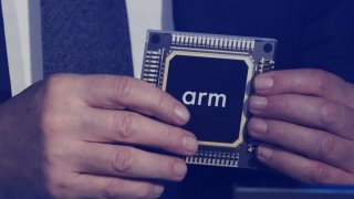 Rene Haas, CEO of chip tech provider Arm Holdings, holds a replica of a chip with his company’s logo on it, during an event in which Malaysia’s Prime Minister Anwar Ibrahim officially announces a $250 million deal with the company, in Kuala Lumpur, Malaysia March 5, 2025.