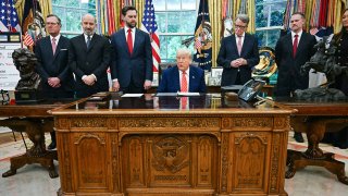 US President Donald Trump makes a trade announcement as US Secretary of Commerce Howard Lutnick (2L), US Vice President JD Vance (3L), British ambassador to the United States Peter Mandelson (3R), US Trade Representative Jamieson Greer (3R) and US Secretary of Agriculture Brooke Rollins (R) look on in the Oval Office of the White House in Washington, DC, on May 8, 2025.