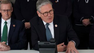 Britain’s Prime Minister Keir Starmer speaks on the phone to U.S. President Donald Trump at a car factory in the West Midlands, Britain, Thursday, May 8, 2025.