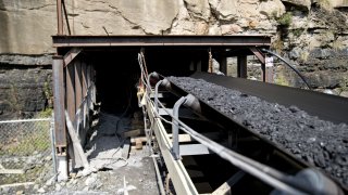 FILE PHOTO: Coal moves on an overland belt from inside the newly opened Ramaco Resources Inc. Stonecoal Alma mine near Wylo, West Virginia, U.S., on Tuesday, Aug. 8, 2017.