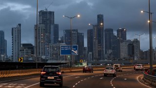 Motorists drive past as clouds gather over city skyline in Mumbai on September 26, 2024. (Photo by Punit PARANJPE / AFP) (Photo by PUNIT PARANJPE/AFP via Getty Images)