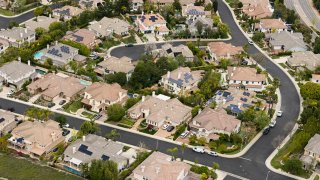 In an aerial view, single family homes neighbor open space on April 18, 2025 in Thousand Oaks, California.