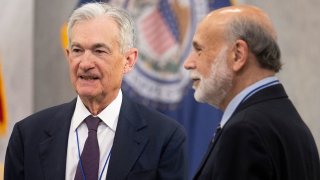 US Federal Reserve Chairman Jerome Powell and Former Federal Reserve Chair Ben Bernanke (R), speak during the Thomas Laubach Research Conference at the William McChesney Martin Jr. Federal Reserve Board Building in Washington, DC, May 15, 2025.
