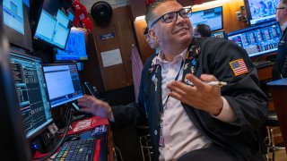 Traders work on the floor of the New York Stock Exchange in New York, May 19, 2025.