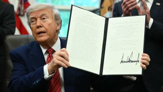US President Donald Trump signs executive orders in the Oval Office of the White House in Washington, DC, on May 23, 2025.