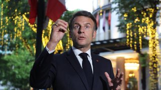 France’s President Emmanuel Macron gives a press statement near the Metropole Hotel before attending a state dinner in Hanoi on May 26, 2025.