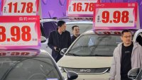 Customers look at BYD electric cars at an auto show in Yantai, in eastern China’s Shandong province on April 10, 2025.