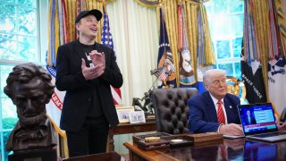 Tesla CEO Elon Musk claps as U.S. President Donald Trump speaks to reporters in the Oval Office of the White House on May 30, 2025 in Washington, DC.