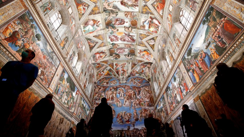 FILE – Visitors admire the Sistine Chapel inside the Vatican Museums on the occasion of the museum’s reopening, in Rome, May 3, 2021.