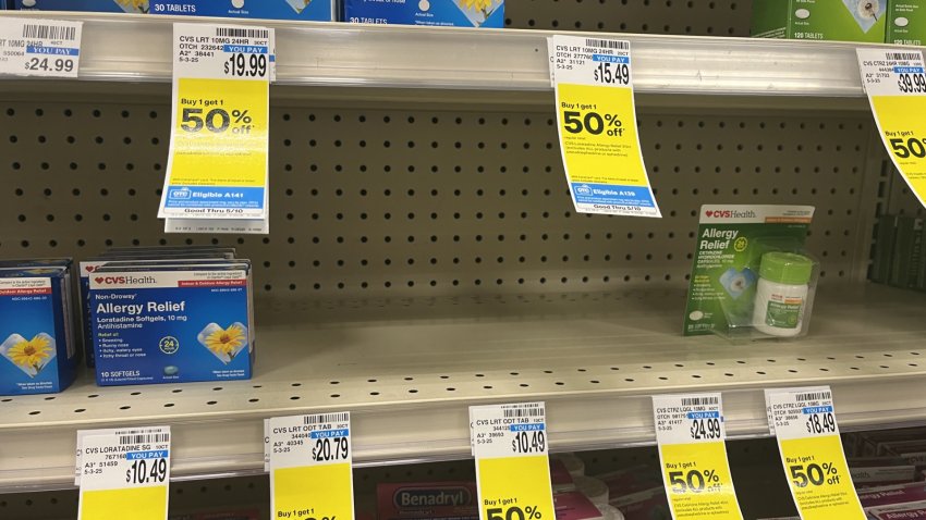 A store shelf filled with some allergy medicatiions.