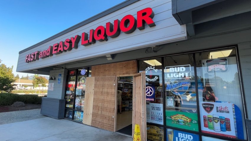 A liquor store in Concord California has wooden boards on the doors and windows