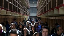 Tourists walk through the main cell block at Alcatraz Island