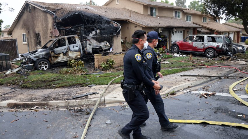 Police officers search the site where a small plane crashed on a San Diego, California, residential street on May 22, 2025. The Federal Aviation Authority said a Cessna 550 crashed at around 3:45 am local time. The neighborhood is close to the Montgomery-Gibbs Executive Airport. The crash left a “gigantic debris field” and damaged some 15 homes and parked cars, ABC News quoted the San Diego assistant fire chief as saying. (Photo by Sandy Huffaker / AFP) (Photo by SANDY HUFFAKER/AFP via Getty Images)