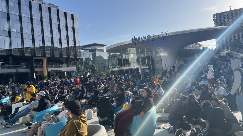 Fans watch the Warriors-Rockets playoffs game five on the big screen at the Thrive City plaza. NBC Bay Area Photo/ Alyssa Goard.