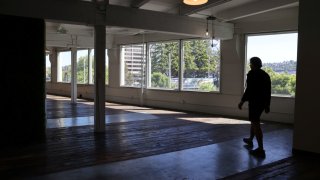 Collin Madden, founding partner of GEM Real Estate Partners, walks through empty office space in a building they own that is up for sale in the South Lake Union neighborhood in Seattle, Washington, May 14, 2021.
