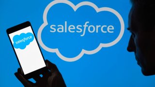 The Salesforce logo is being displayed on a smartphone, with Salesforce in the background, in this photo illustration in Brussels, Belgium, on June 16, 2024.