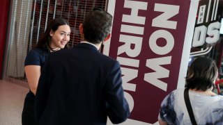 =Kiaraliz Irizarry (L) recruits people for jobs at Triton Recovery during the Mega JobNewsUSA South Florida Job Fair held in the Amerant Bank Arena on April 30, 2025 in Sunrise, Florida.