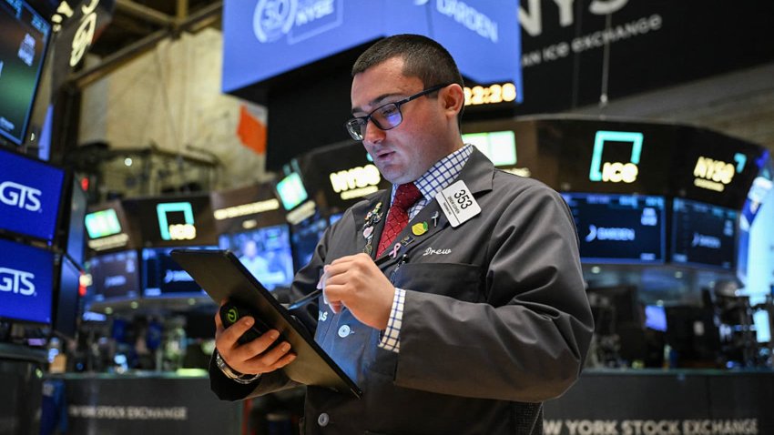 A trader works on the floor of the New York Stock Exchange (NYSE) at the opening bell on May 30, 2025, in New York City.