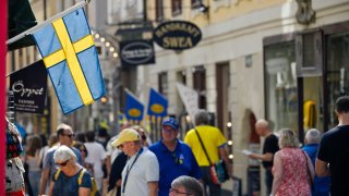 A Swedish national flag hanging from a shop in Gamla Stan in Stockholm, Sweden, on Thursday, Aug. 18, 2022.