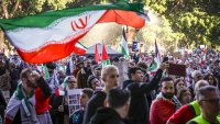 Protesters in support of Iran and Palestinians in Gaza hold flags and placards during a demonstration against the actions of Israel and the United States in Sydney on June 22, 2025.