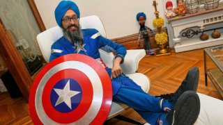 Vishavjit Singh, who educates youth about Sikhism through his Captain Sikh America character, poses for a portrait in costume at home