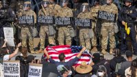 LOS ANGELES, CALIFORNIA – JUNE 09: Protesters confront California National Guard soldiers and police outside of a federal building as protests continue in Los Angeles following three days of clashes with police after a series of immigration raids on June 09, 2025 in Los Angeles, California. Tensions in the city remain high after the Trump administration called in the National Guard against the wishes of city leaders.  (Photo by David McNew/Getty Images)
