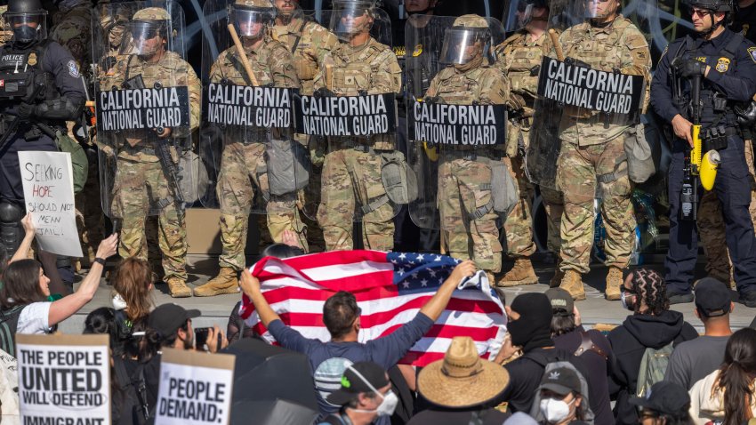 LOS ANGELES, CALIFORNIA – JUNE 09: Protesters confront California National Guard soldiers and police outside of a federal building as protests continue in Los Angeles following three days of clashes with police after a series of immigration raids on June 09, 2025 in Los Angeles, California. Tensions in the city remain high after the Trump administration called in the National Guard against the wishes of city leaders.  (Photo by David McNew/Getty Images)