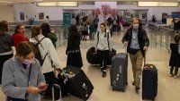 People carrying suitcases arrive from international flight at Newark Liberty International Airport, Monday, June 9, 2025, in New Jersey.