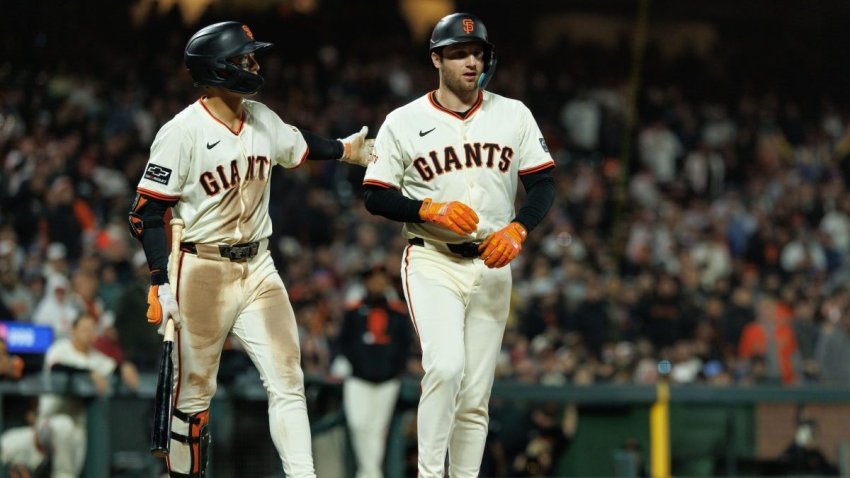 Jun 25, 2025; San Francisco, California, USA; San Francisco Giants first baseman Casey Schmitt (10) walks to first after getting hit by a pitch during the ninth inning against the Miami Marlins at Oracle Park. Mandatory Credit: Sergio Estrada-Imagn Images