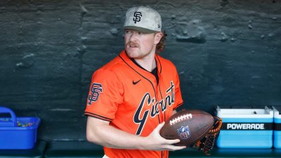 SAN FRANCISCO, CALIFORNIA – MAY 16: Logan Webb #62 of the San Francisco Giants holds a football in the dugout before the game against the Athletics at Oracle Park on May 16, 2025 in San Francisco, California. (Photo by Lachlan Cunningham/Getty Images)