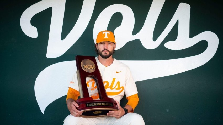 Tennessee baseball head coach Tony Vitello, Knox News Sportsperson of the Year, poses for a portrait with the team’s 2021 College World Series participant trophy at Lindsey Nelson Stadium in Knoxville, Tenn. on Thursday, Dec. 16, 2021.