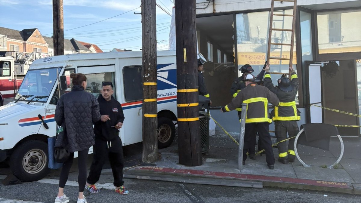 USPS truck backs into building in San Francisco