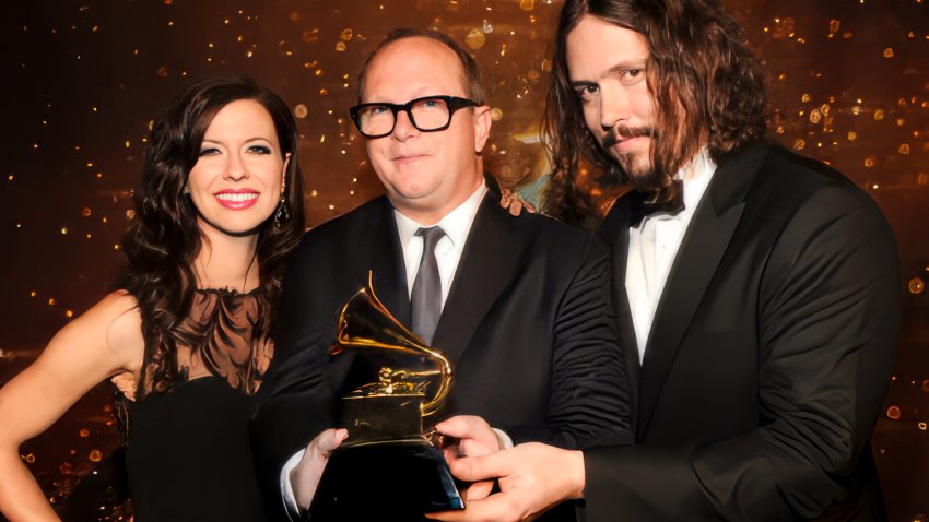 Producer/musician Charlie Peacock stands with Joy Williams and John Paul White after winning a Grammy Award for the group’s album Barton Hollow.