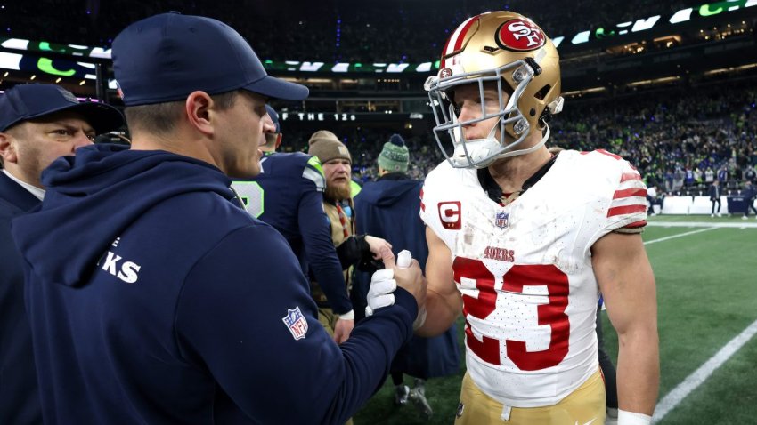 SEATTLE, WASHINGTON – JANUARY 17: Head coach Mike MacDonald of the Seattle Seahawks shakes hands with Christian McCaffrey #23 of the San Francisco 49ers after the NFC Divisional Playoff game at Lumen Field on January 17, 2026 in Seattle, Washington.  (Photo by Harry How/Getty Images)