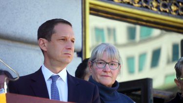 San Francisco Mayor Daniel Lurie stands alongside Helen Horvath on the steps of City Hall at a rally organized in support of Ken Jones.