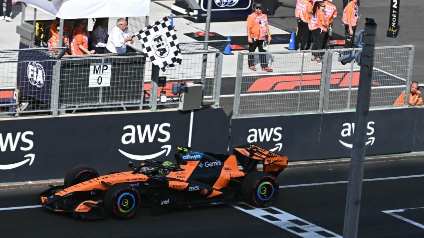 Lando Norris drives over the finish line