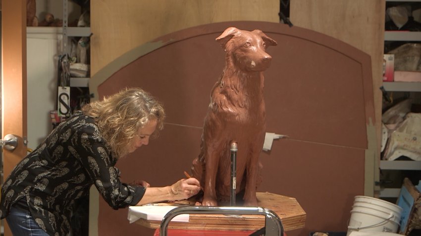 Artist Susan Bahary creates a dog out of clay inside her Novato studio.