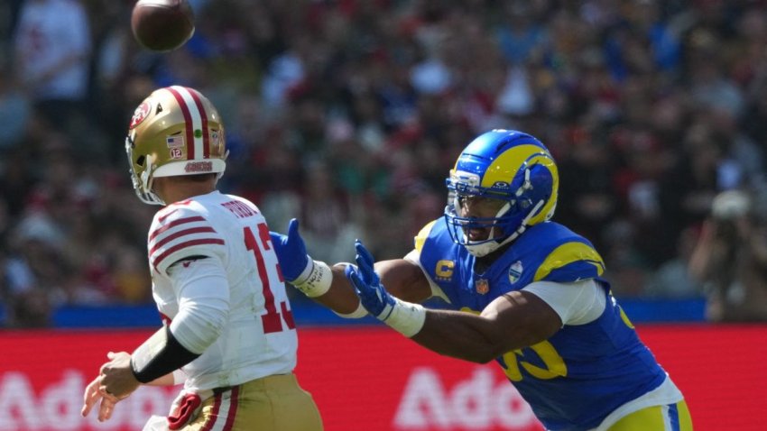 Sep 11, 2026; Melbourne, AUS;  Los Angeles Rams defensive end Myles Garrett (95) pressures San Francisco 49ers quarterback Brock Purdy (13) in the first half at Melbourne Cricket Ground.  Mandatory Credit: Kirby Lee-Imagn Images