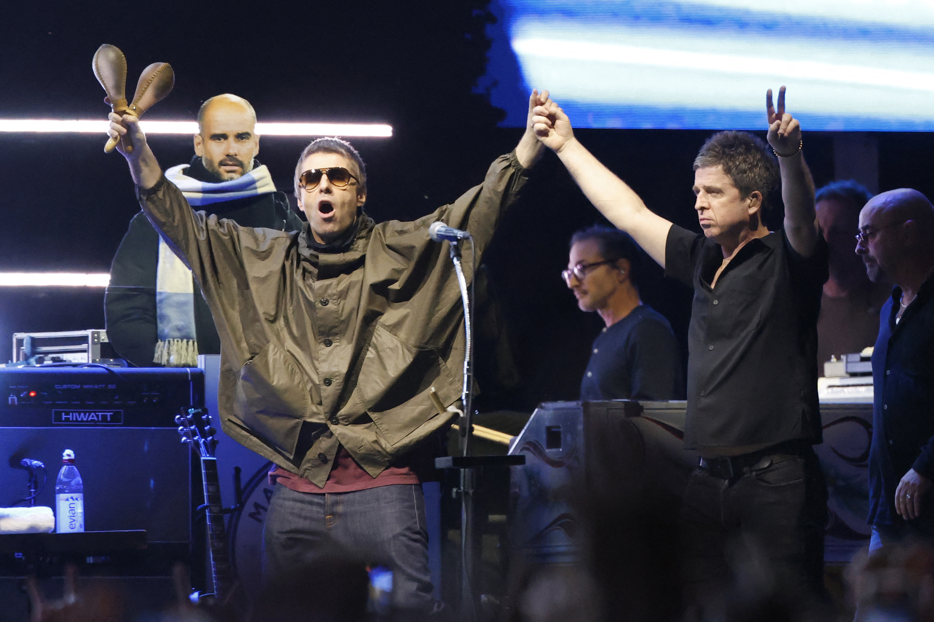 Members of British rock band Oasis, including Liam Gallagher and Noel Gallagher, arrive on stage at Soldier Field in Chicago on Aug. 28, 2025, during their reunion tour.