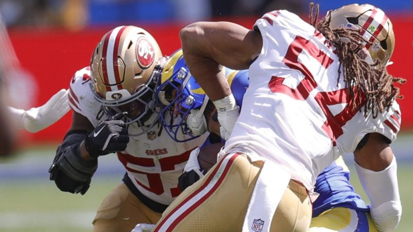 MELBOURNE, AUSTRALIA – SEPTEMBER 11: Dre Greenlaw #57 and Fred Warner #54 of the San Francisco 49ers tackle Blake Corum #24 of the Los Angeles Rams during the game at the Melbourne Cricket Ground on September 11, 2026 in Melbourne, Australia. The 49esr defeated the Rams 27-7. (Photo by Michael Zagaris/San Francisco 49ers/Getty Images)