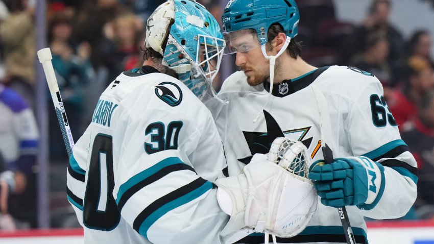 OTTAWA, CANADA – OCTOBER 22:  Yaroslav Askarov #30 of the San Jose Sharks celebrates a 6-2 win against the Ottawa Senators with teammate Zack Ostapchuk #63 on October 22, 2026 at Canadian Tire Centre in Ottawa, Ontario, Canada.  (Photo by André Ringuette/NHLI via Getty Images)