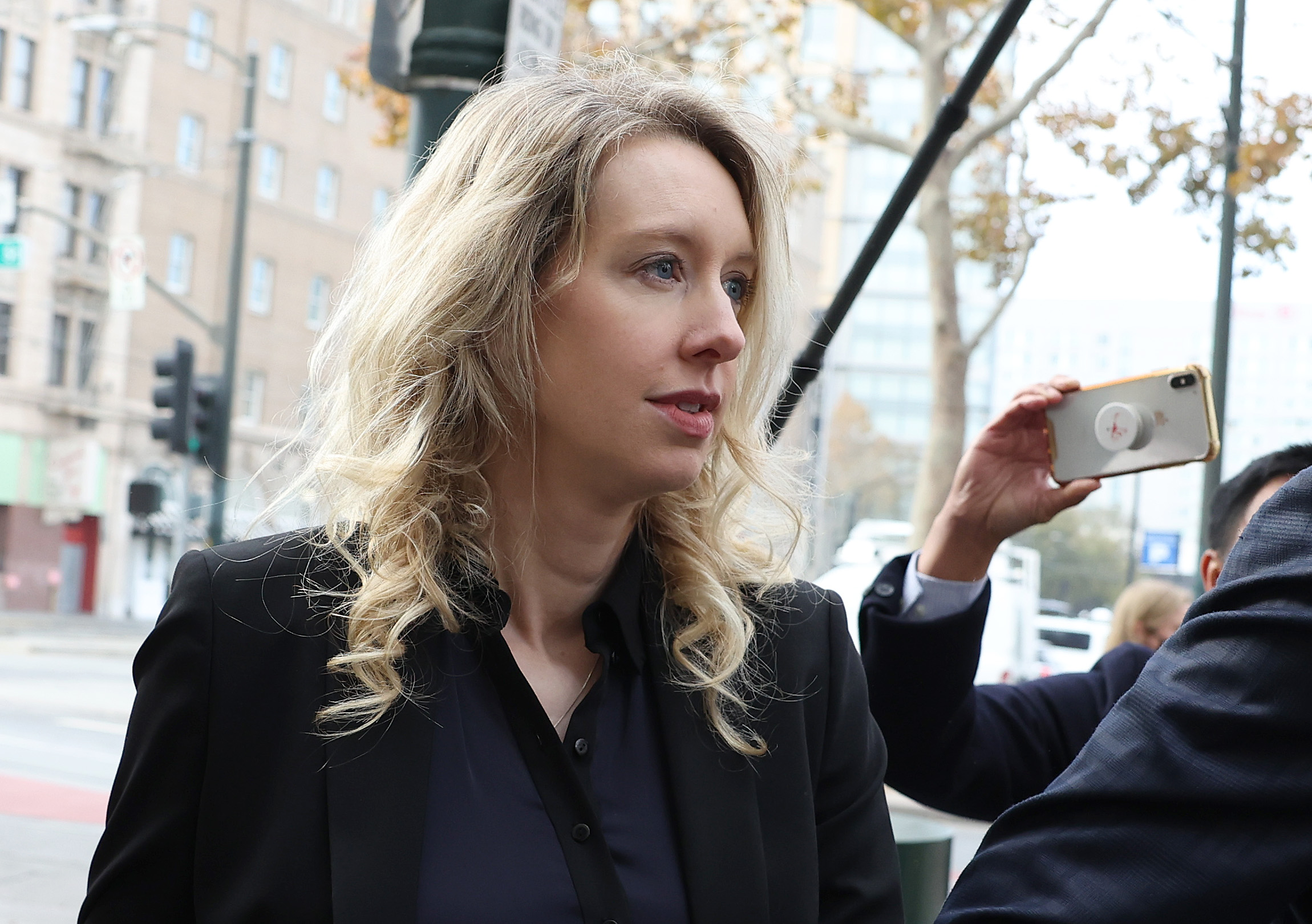 Who is Elizabeth Holmes and what did she do?